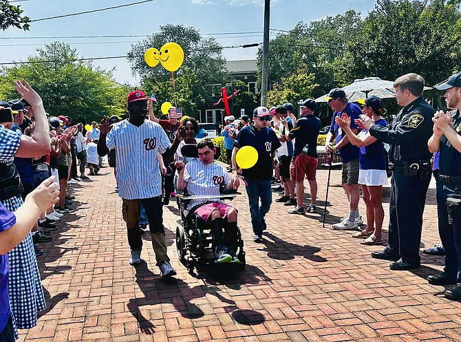 Miracle League players enter the stadium prior to the Sept. 6 game at the Nannie J. Lee Recreation Center. The game was the 14th annual Miracle League tribute to first responders.