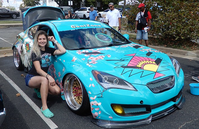 Lorton’s Hannah Mead poses with her 2011 Hyundai Genesis coupe, sponsored for display by Arizona Iced Tea. It even sports a flamingo gearshift.