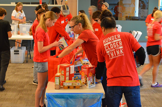 Nearly 1,000 Food For Neighbors volunteers supported 54 schools and over 10,000 students in Fairfax, Arlington and Loudoun counties by collecting and sorting more than 28,000 pounds of food for local school children on Sept. 13.