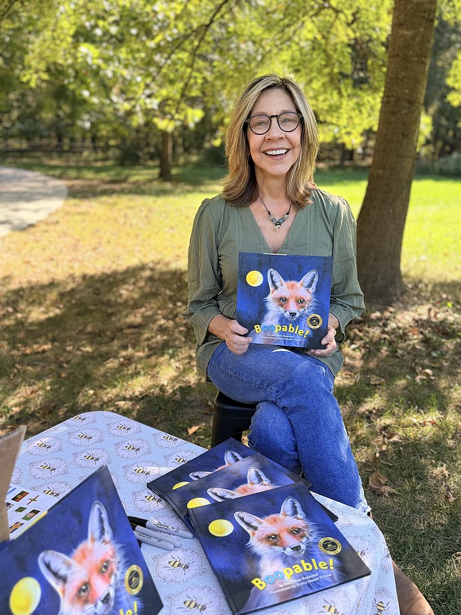 Author and entertainer Mary Ann Redmond of Great Falls with her recently published children’s book during the Global Passport Adventure at Wolf Trap on Oct. 5.