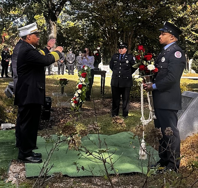 AFD Chief Filipe Hernandez and Alexandria Volunteer Fire Department president Jay Johnson salute after placing the wreath at the Fallen Firefighters memorial Oct. 10 at Ivy Hill Cemetery.