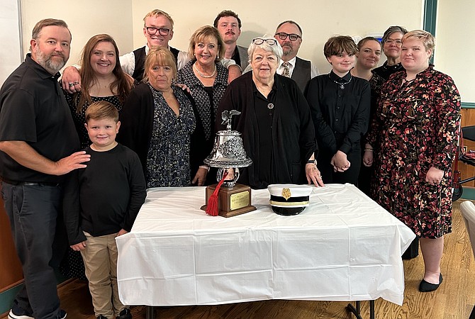 Schmidt’s family behind the bell rung for the 5-5-5 alarm tribute and his past fire chief’s cap.