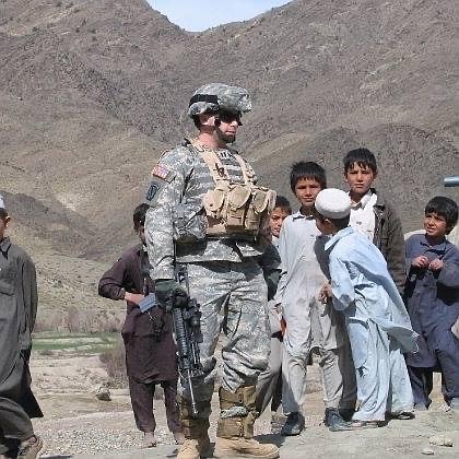 Berkoff in Afghanistan with children looking on.