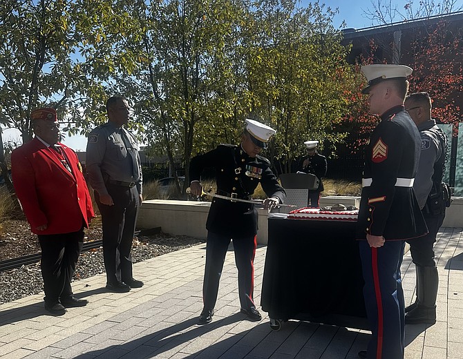 Officer Neale Marquez, center, uses a sword to cut a cake during the Nov. 12 APD ceremony celebrating 250 years of the U.S. Marine Corps. Looking on are Commandant Michael Jadoo, APD Chief Tarrick McGuire, Officer Alex Trapero and Officer Maxwell VanArsdale.