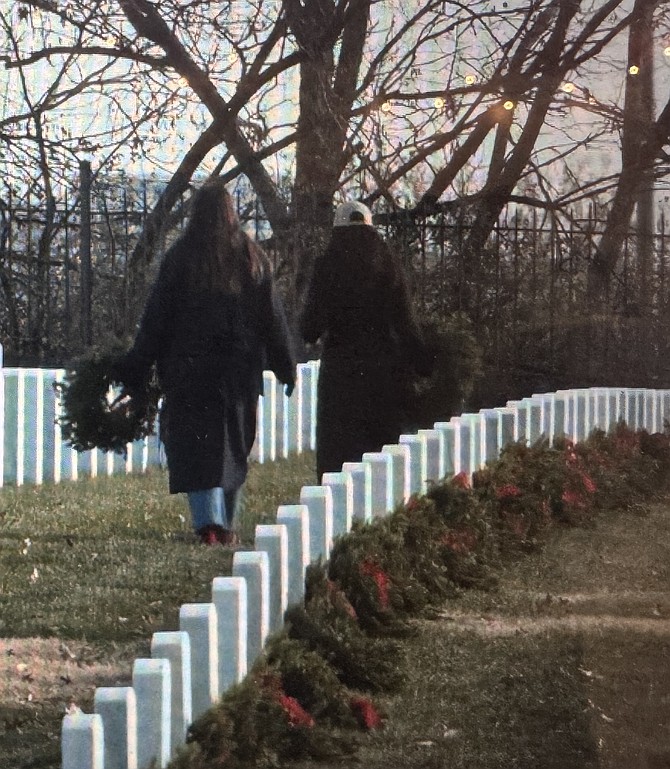 Volunteers walk among the gravesites during Wreaths Across America Dec. 14 at Arlington National Cemetery.