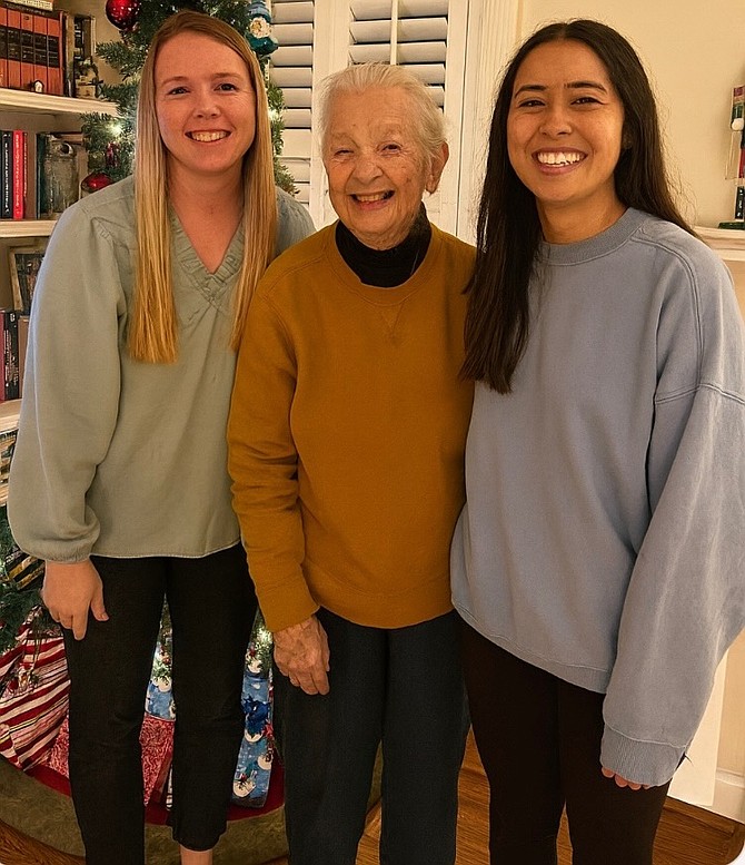 The decorations matter, but so does the company. Fix-It Friday Holiday Workshop Elves Jordan Ryan (left) and Jennifer Lee (right) helped transform the home of Margaret Ellis (center).