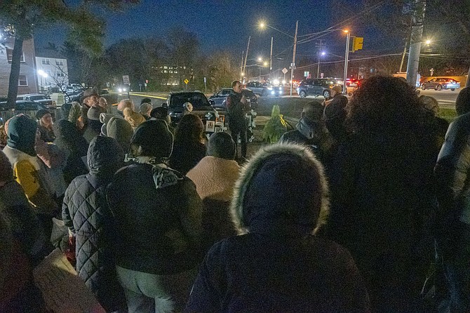 The crowd on a cold night at a prayer vigil for immigrants focuses on Mount Vernon Supervisor Dan Storck who gave impromptu remarks of support.