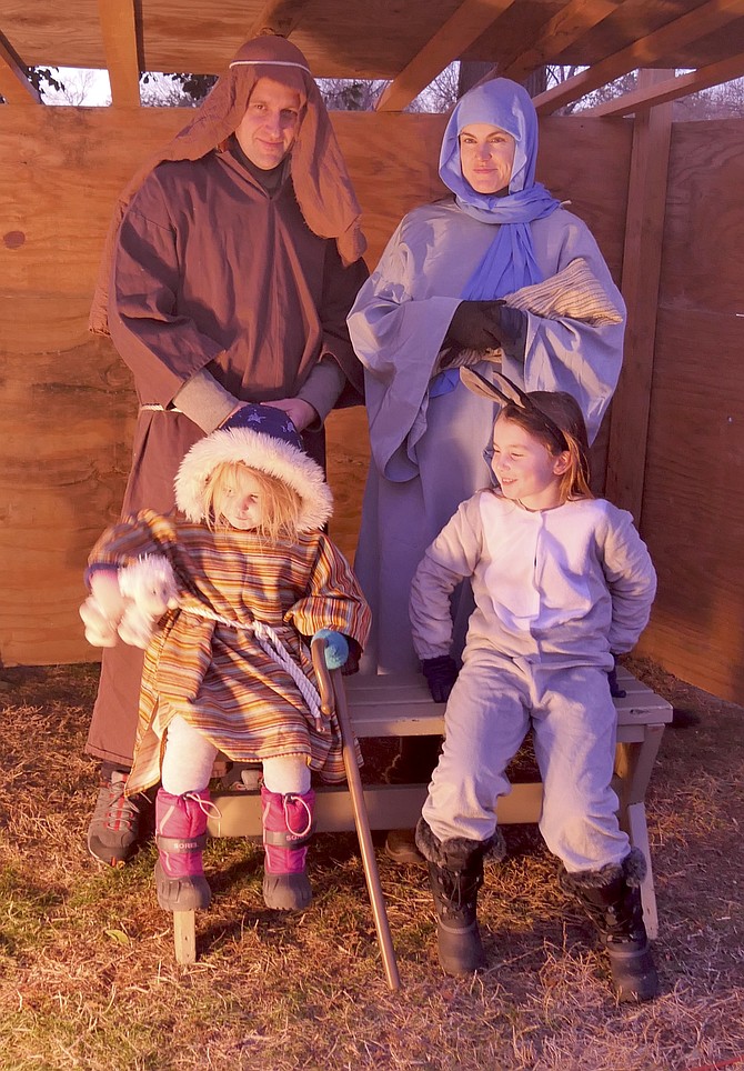 Mary and Joseph “for the night” stood in the manger scene at the live nativity held by Mount Olivet on Dec. 21. Mary explained she was holding a plastic baby Jesus in the swaddling blanket because she said they couldn’t get a volunteer baby from the congregation on such a cold night.