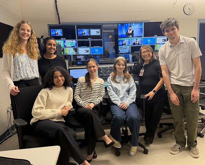 ACPS TV Media production program teacher Vilma Zefran, standing second from left, poses with her students in the new control room of the broadcast studio Dec. 12, 2025, at Alexandria City High School.