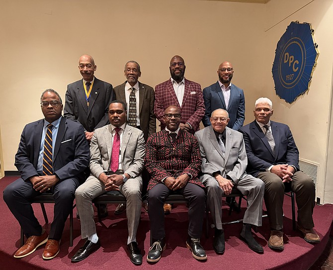 Vaughn Ambrose, front center, sits with newly installed officers of the Departmental Progressive Club Jan. 9 at the DPC headquarters in Old Town.