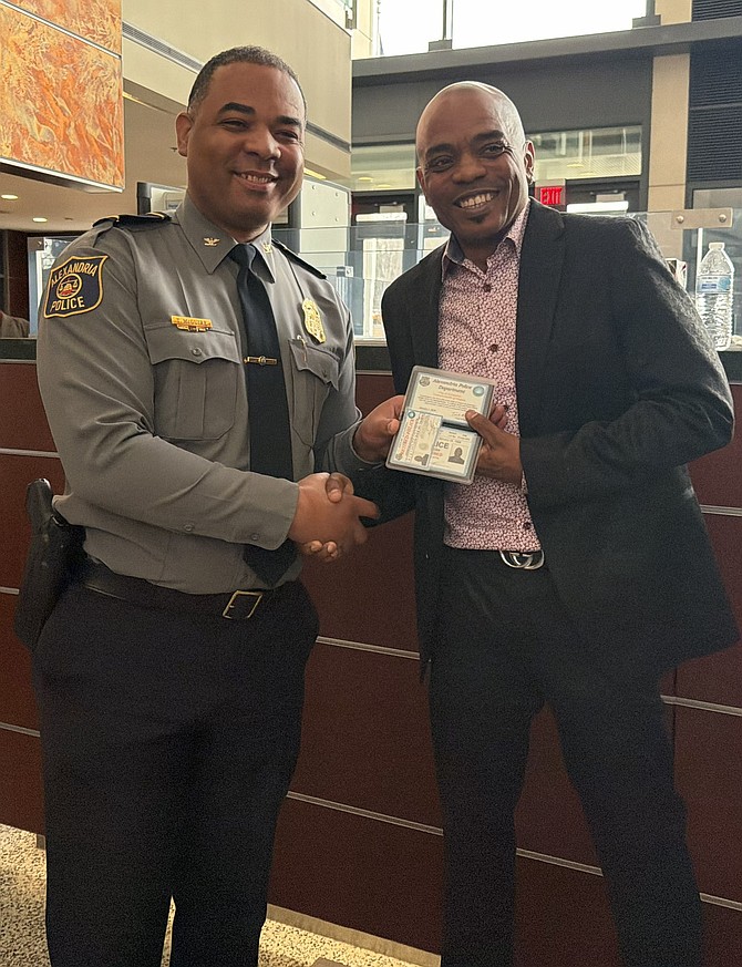 Chief Tarrick McGuire, left, makes a presentation to Officer Bennie Evans Jan. 5 at APD headquarters. Evans retired following nearly three decades in law enforcement