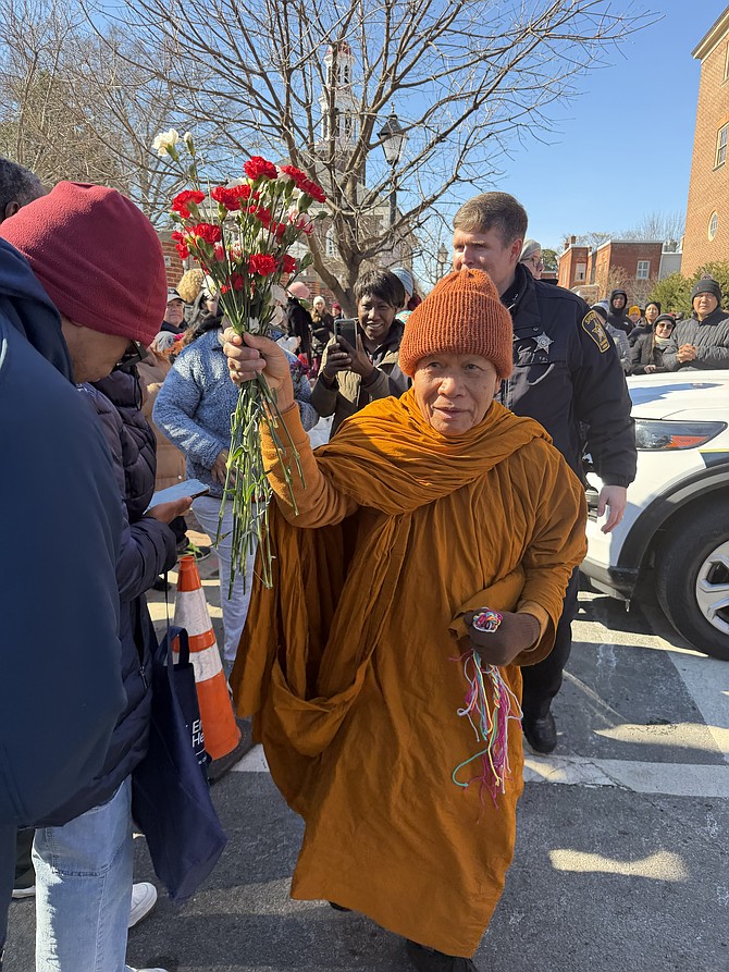 Crowds line the streets as a Buddhist monk makes his way through Old Town during the Feb. 9 Walk for Peace.
