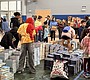 Families and teachers crowd the event with bags, …