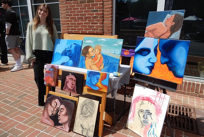 Ava Stezin with her vibrant oil portraits.