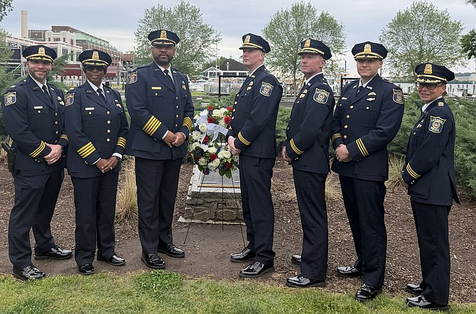 Alexandria Police Chief Tarrick McGuire, third from left, stands with his staff at the annual wreath laying ceremony at the Fallen Officers Memorial May 7 at Waterfront Park. Pictured are: Capt. Greg Simon, Asst. Chief Tina Laguna, Chief McGuire, Capt. Dennis Andreas, Asst. Chief Mike May, Asst. Chief Jason North and Capt. Tara Delio May.