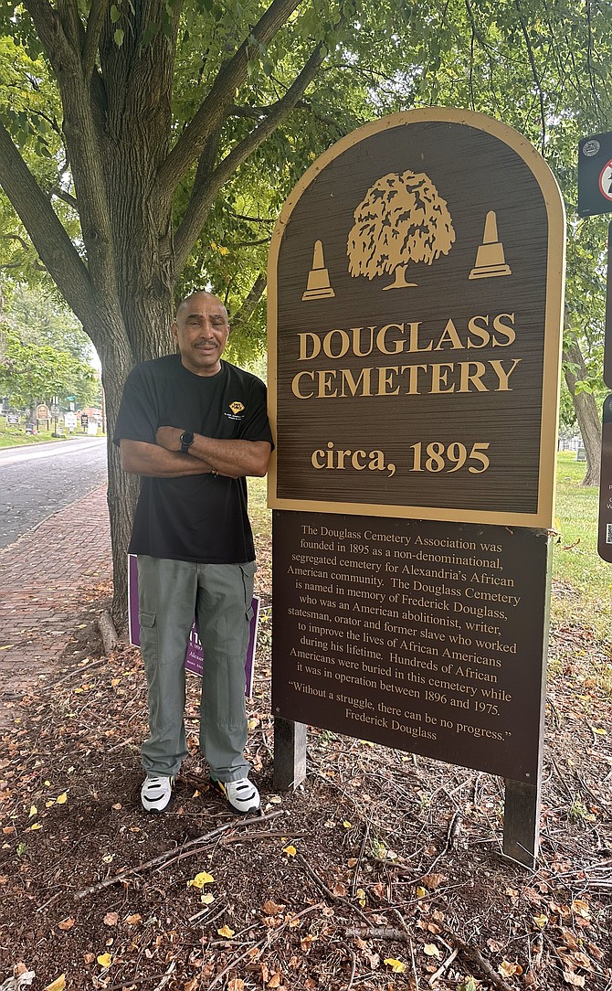 Juneteenth committee member Michael Johnson stands at the entrance to the historic Douglass Cemetery on Wilkes Street. The cemetery kicks off the city’s Juneteenth day of events with a memorial program at 10 a.m.
