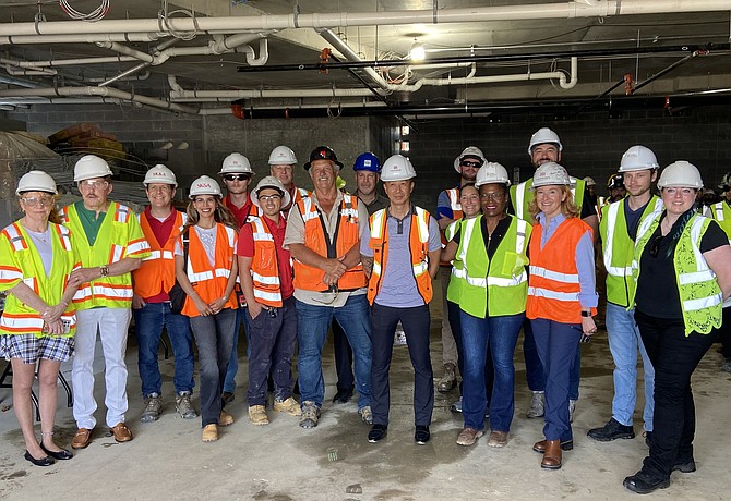 Posing together are personnel from The Lamb Center, Wesley Housing and the construction team, plus invited guests.