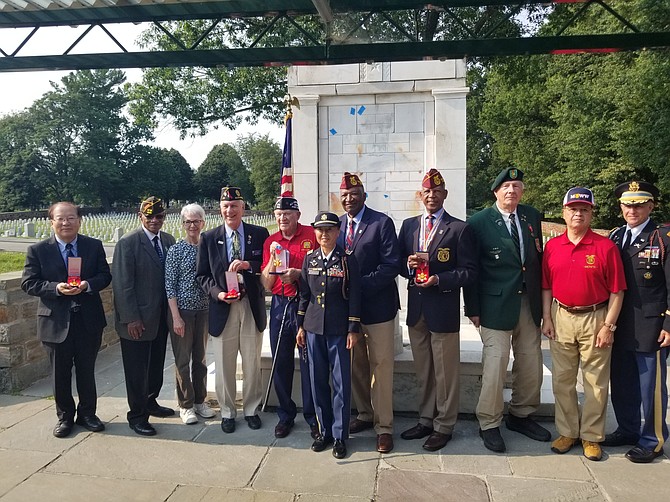 Members of Veteran Service Organizations pose for a photo after being presented with the Korean government’s Medal of Appreciation during the commemoration of the Korean War Armistice on July 27 at Alexandria National Cemetery.