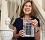 Author Lisa Marie Gring-Pemble holds the book she …