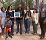 Chris Thomas, center presents an original poem to …